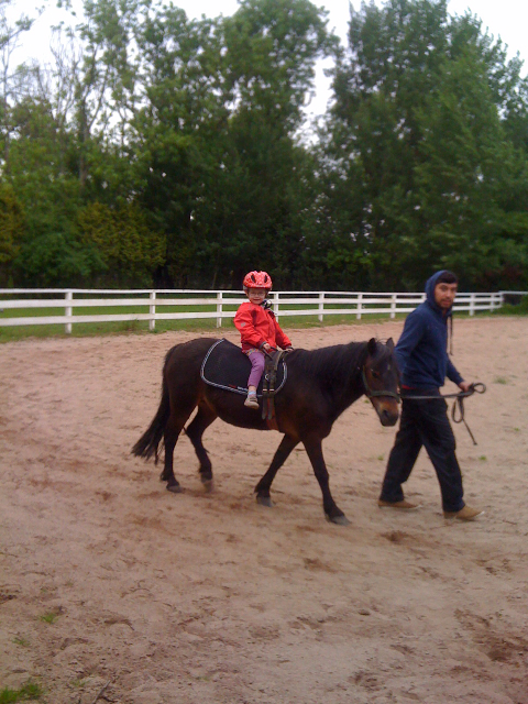 Charlie auf dem Pony mit Betreuer